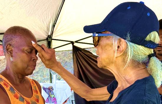 Mother Gwendolyn Smith anointing Sister Audrey Wright with blessed oil